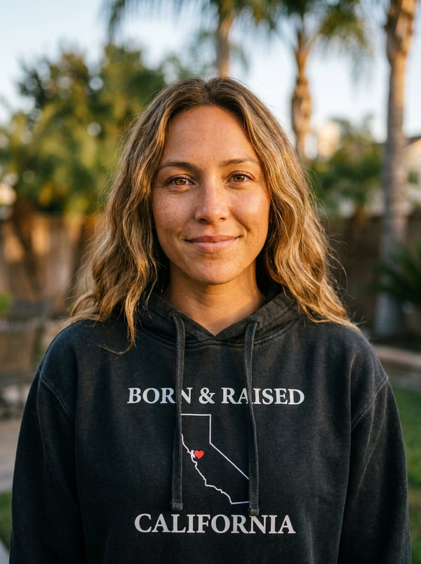 Woman wearing California Born and Raised Hoodie t-shirt in California backyard